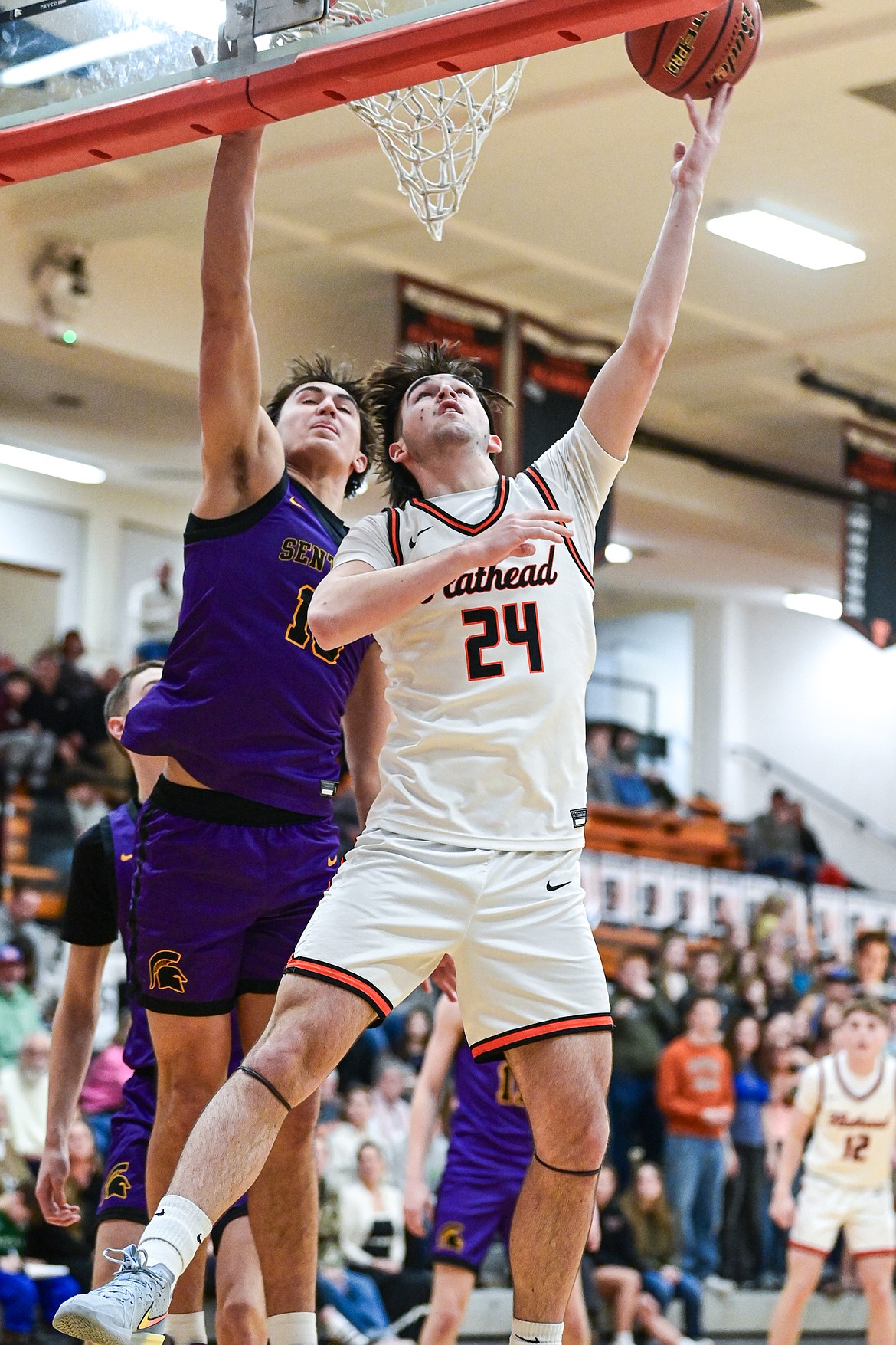Flathead's Boston Case (24) goes to the rim for a reverse layup in the first half against Missoula Sentinel at Flathead High School on Tuesday, Feb. 10. (Casey Kreider/Daily Inter Lake)