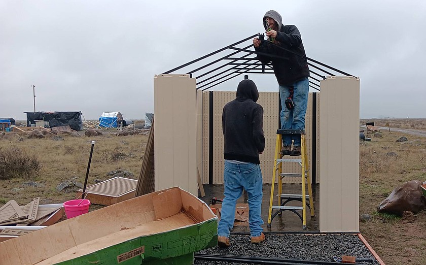 Volunteers assemble a shed donated to Rock Bottom Rocker Pet Pantry last week. Another donation to the pet rescue allows folks who want to adopt a dog to skip the adoption fees through February.