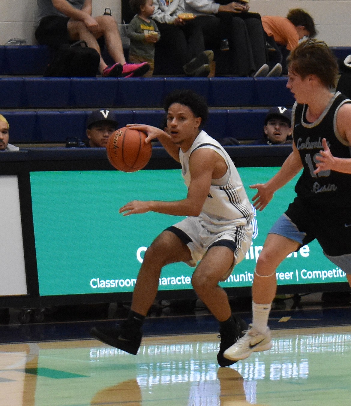 The Vikings’ Lorenzo Contreras (1) drives the ball up the court against Columbia Basin College. Contreras finished the game with six assists.