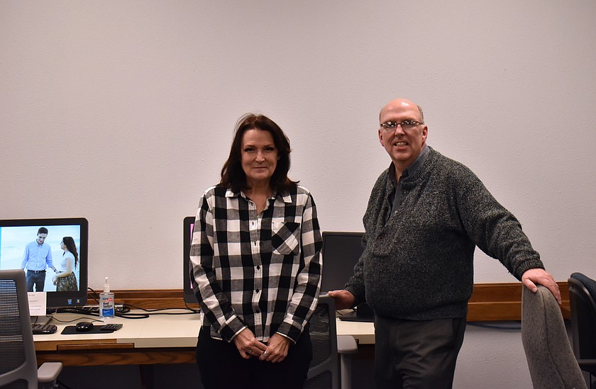 Gwen Bruce, left, and Jeff Stevens stand in the Church of Jesus Christ of Latter-day Saints FamilySearch Center on Division Street. They, and a team of occasional volunteers, help anybody who wants to research their family history at no charge.