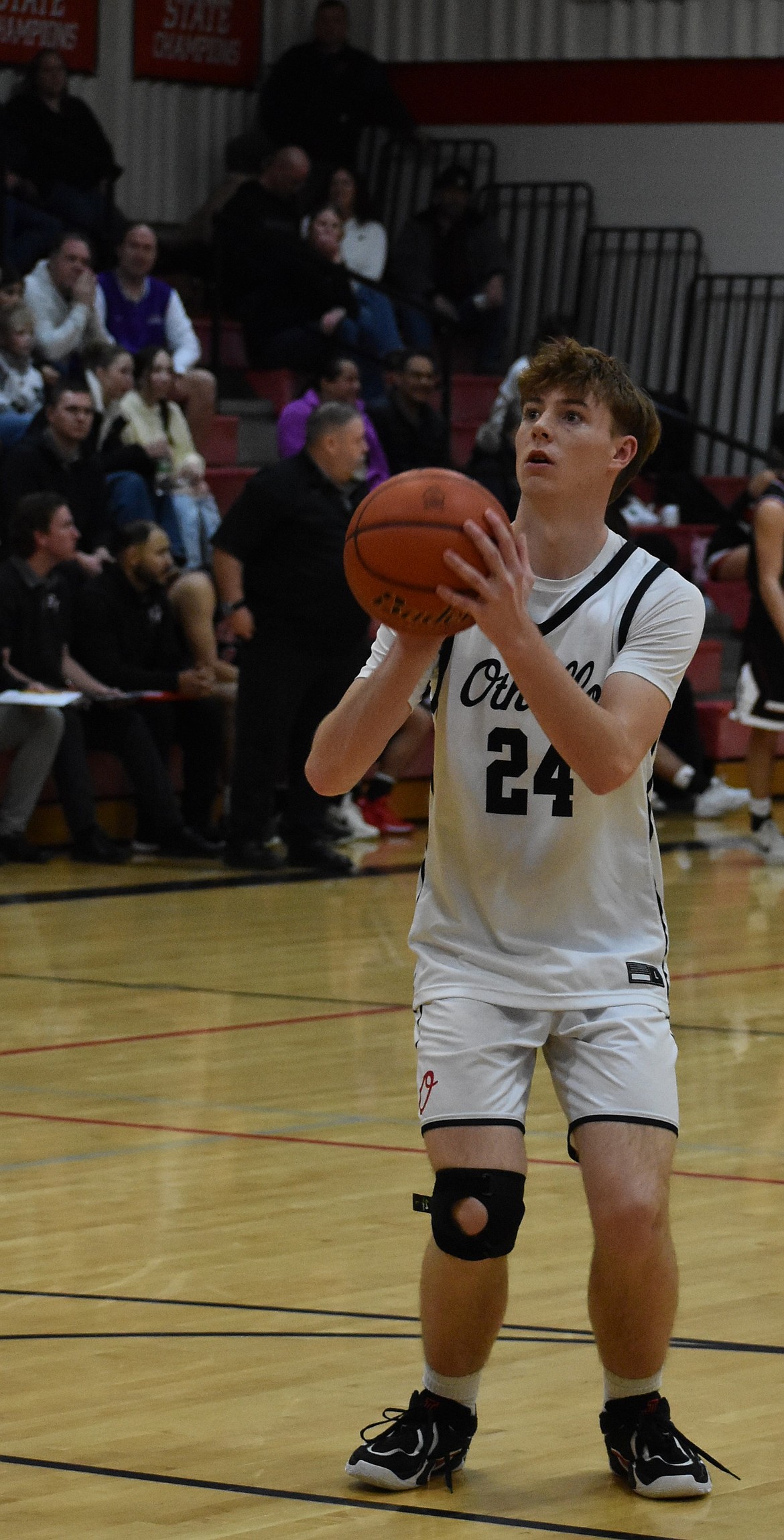 Othello senior Josh Lawson aims to make a free throw to keep the team ahead of East Valley Wednesday evening in the district playoffs.