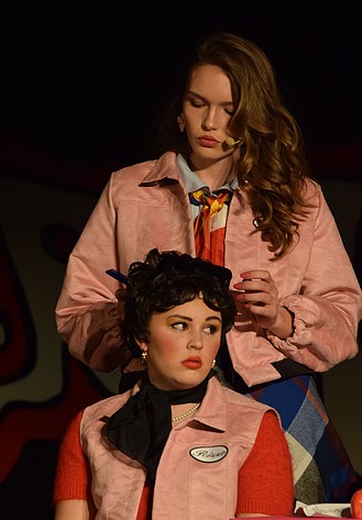 Frenchy (Megan Truscott) combs Betty Rizzo’s (McKinnley Graaff) hair during the opening night of Ephrata High School’s production of “Grease.”