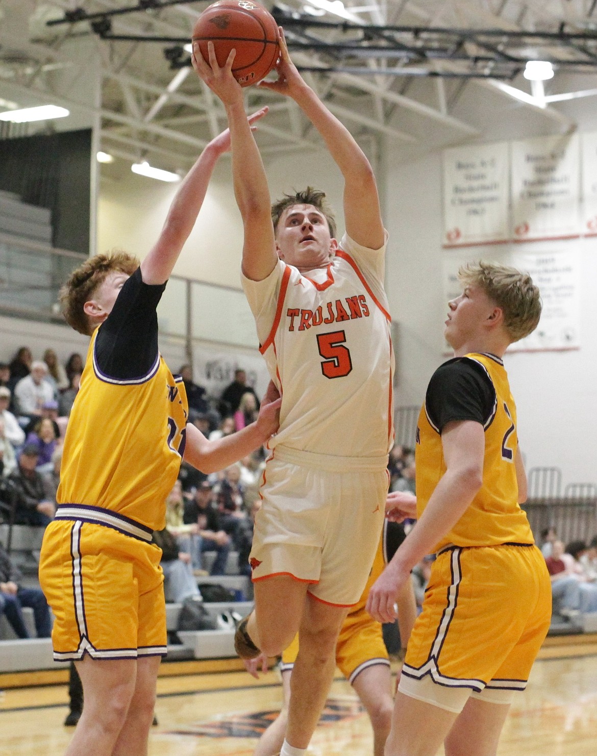 MARK NELKE/Press
Post Falls senior Jaxon Lysne (5) splits Lewiston defenders Brady Rudolph, left, and Royce Fisher in the first half Friday night at The Arena.
