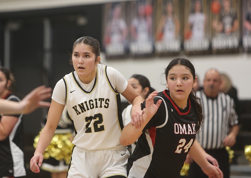 Graycie Kast (22) guards her opponent from Omak closely. Kast led the team with 39 points as the Royal Knights defeated the Omak Pioneers 74-30 Thursday in the first round of the 1A district 5 tournament.