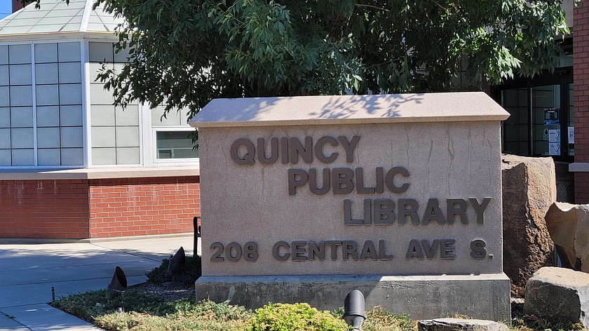 Sun shines down on the Quincy Public Library sign last summer. If the walls are creeping in a little too close and an escape from cabin fever is on the horizon, joining a club at your local library or just checking out a book, audiobook or movie may go a long way toward helping.