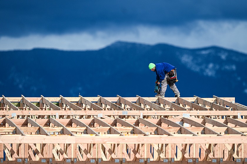 A construction worker works on the roof of a building under construction along Four Mile Drive on Saturday, Feb. 14. (Casey Kreider/Daily Inter Lake)