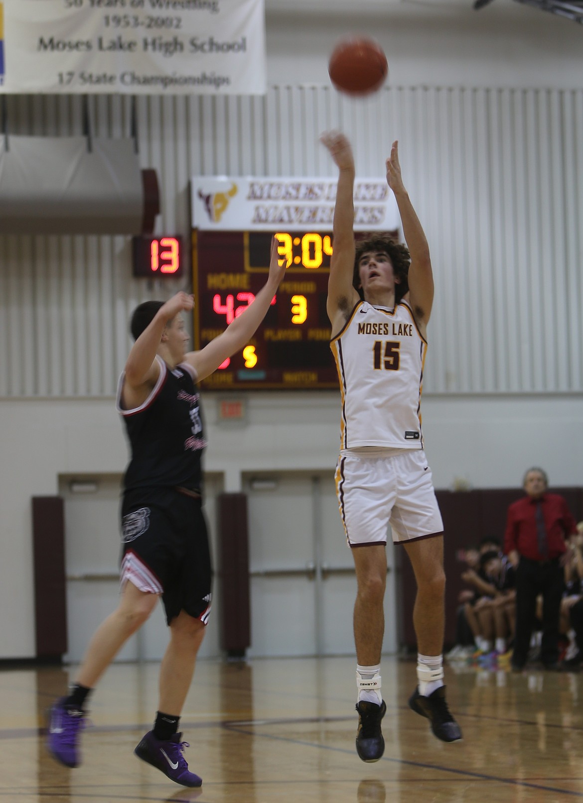 The Mavericks’ Grady Walker (15) shoots over a Sunnyside defender Friday. Moses Lake defeated Sunnyside 72-64.