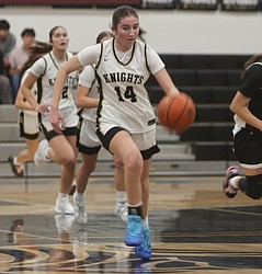 The Knights’ Lauren Wardenaar (14) pushes the ball up the court against Omak. Royal defeated Omak 74-30 to advance further into the 1A district tournament.