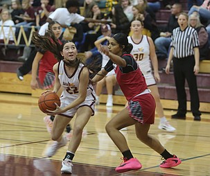 Reese Char (22) drives to the basket against a Sunnyside defender. The Mavericks suffered a loss at home 46-40 to the Grizzlies Friday. Head Coach Matt Strophy said he was proud of their efforts.