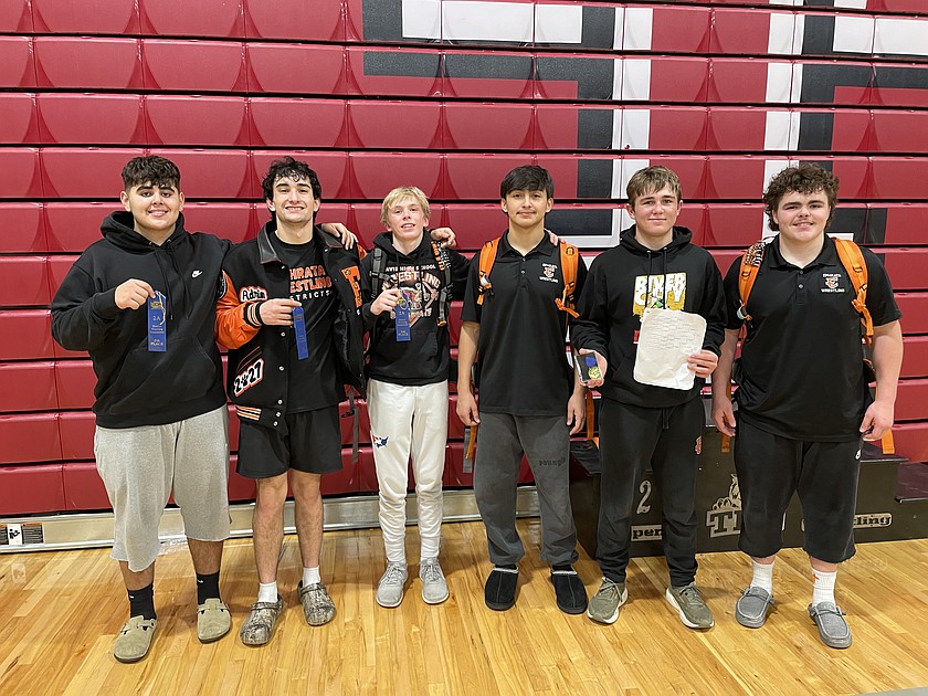 The Tigers boys wrestlers, Derren Hernandez, Adrian Negrette, Louden Leenhouts, Carter Carcia, Colt Staples and Payton Woods line up together in the Toppenish gym after qualifying for state.