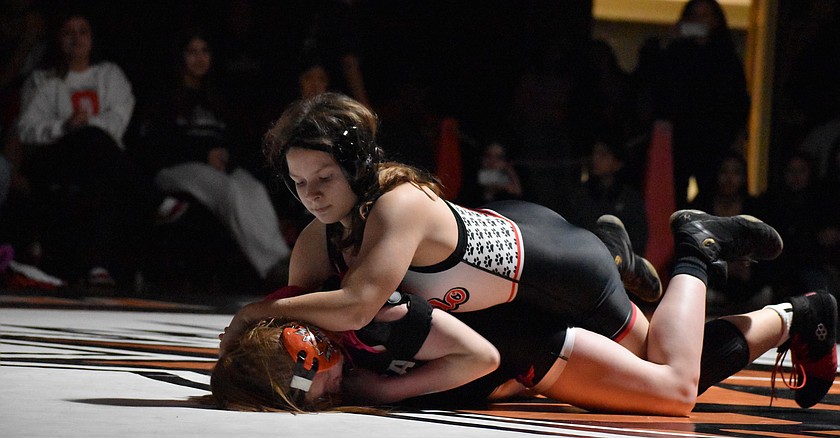 Freshman Addie Russell from the Huskies drives her opponent into the ground during a matchup earlier this season. Russell took first in the 140-lb bracket.