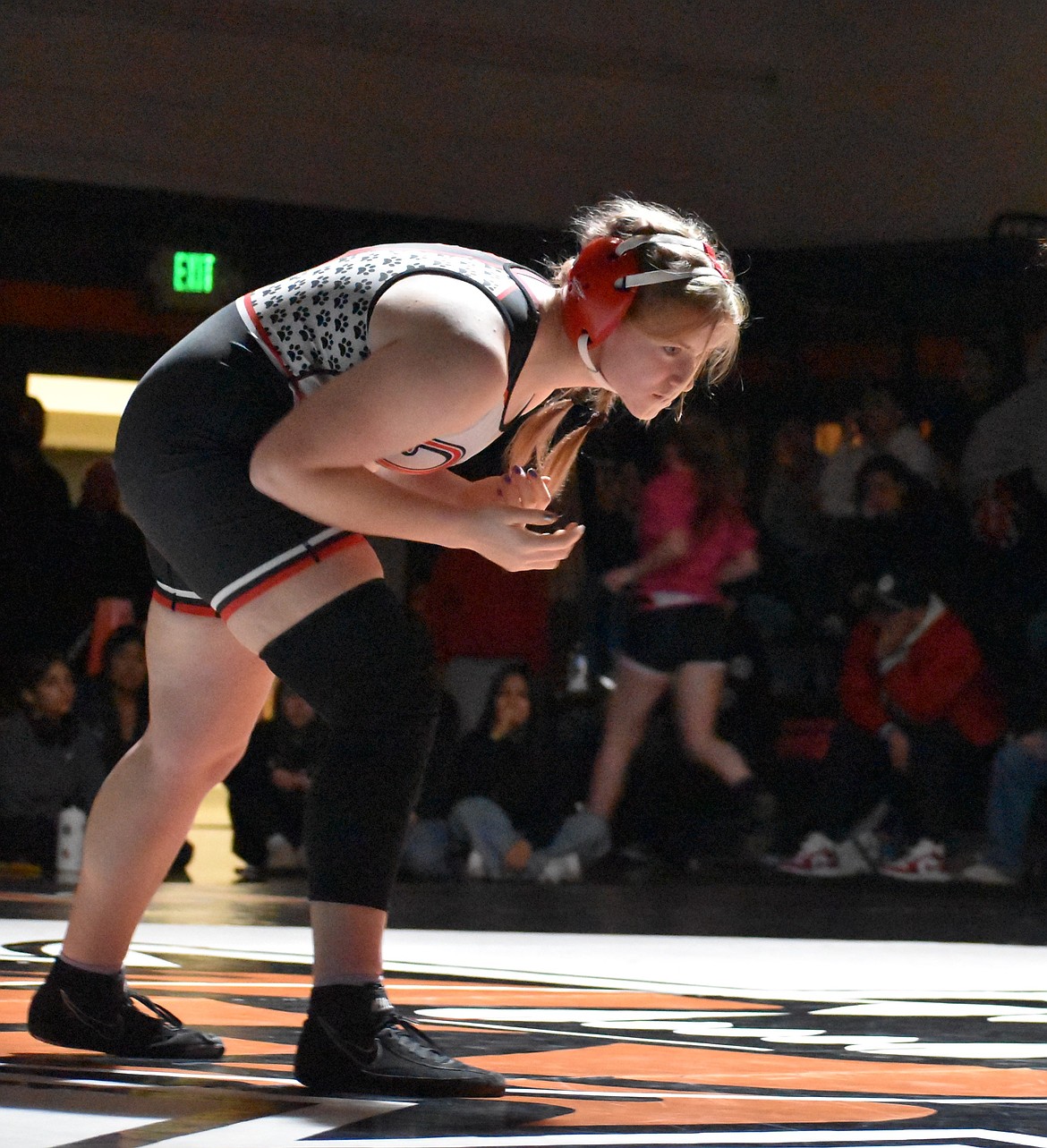 Lucy Gilbert from the Huskies looks for an opening against her opponent earlier in the season. Gilbert qualified for state by taking second in the 170-lb bracket.