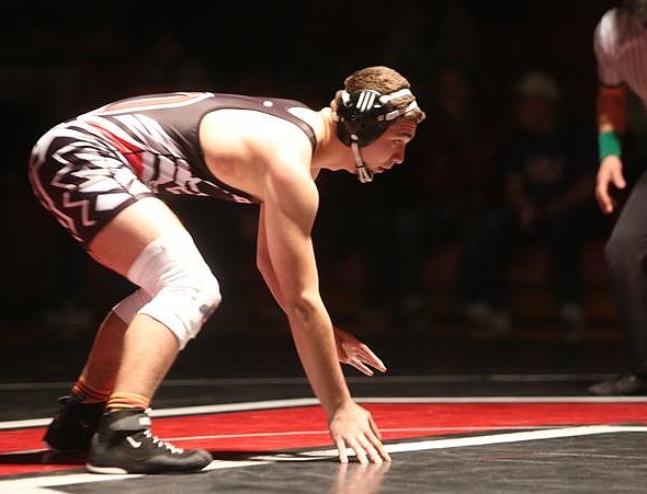 Camillo Mendes III, a senior from the Huskies, gets ready to battle against his opponent during a previous home meet this season. Mendes finished first in the 150-lb bracket to become a district champion Saturday.