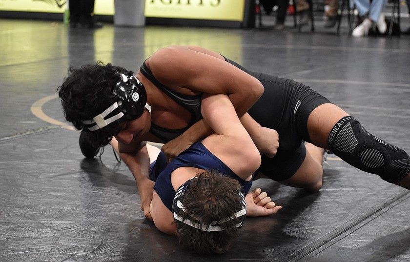 Andy Calderon from the Knights takes on a wrestler from Davenport at a home tourney earlier this season.
