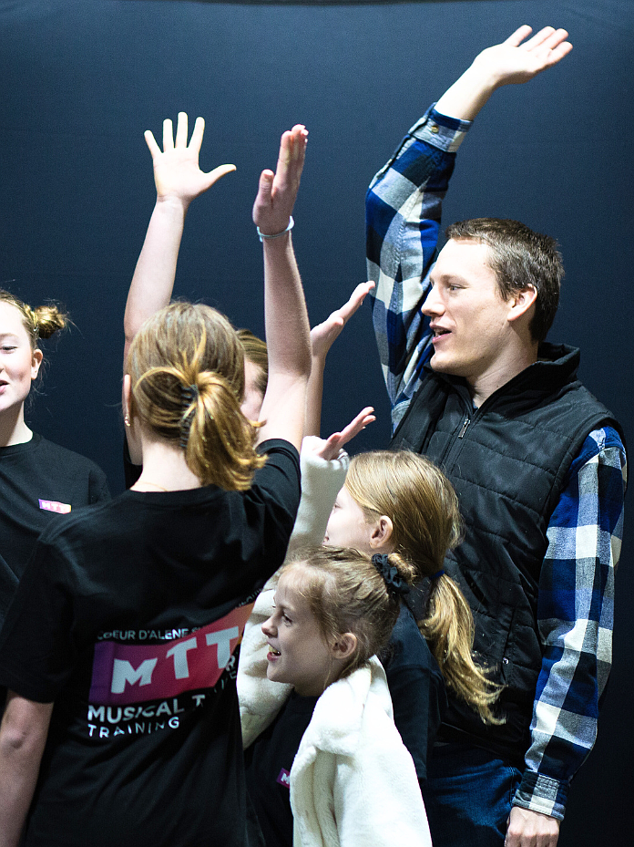 Scott Michaelsen, studio training music director for Coeur d'Alene Summer Theatre, leads an exercise with youth students.