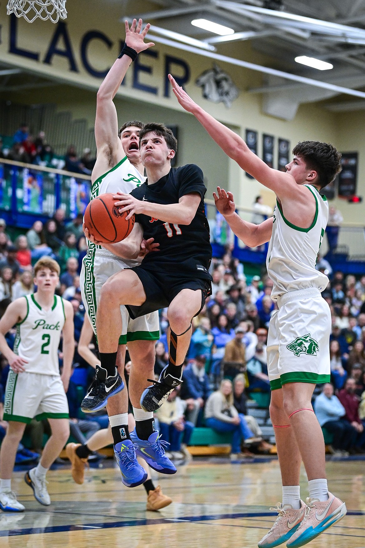 Flathead's Ben Reichard (11) drives to the basket in the third quarter agianst Glacier at Glacier High School on Thursday, Feb. 19. (Casey Kreider/Daily Inter Lake)