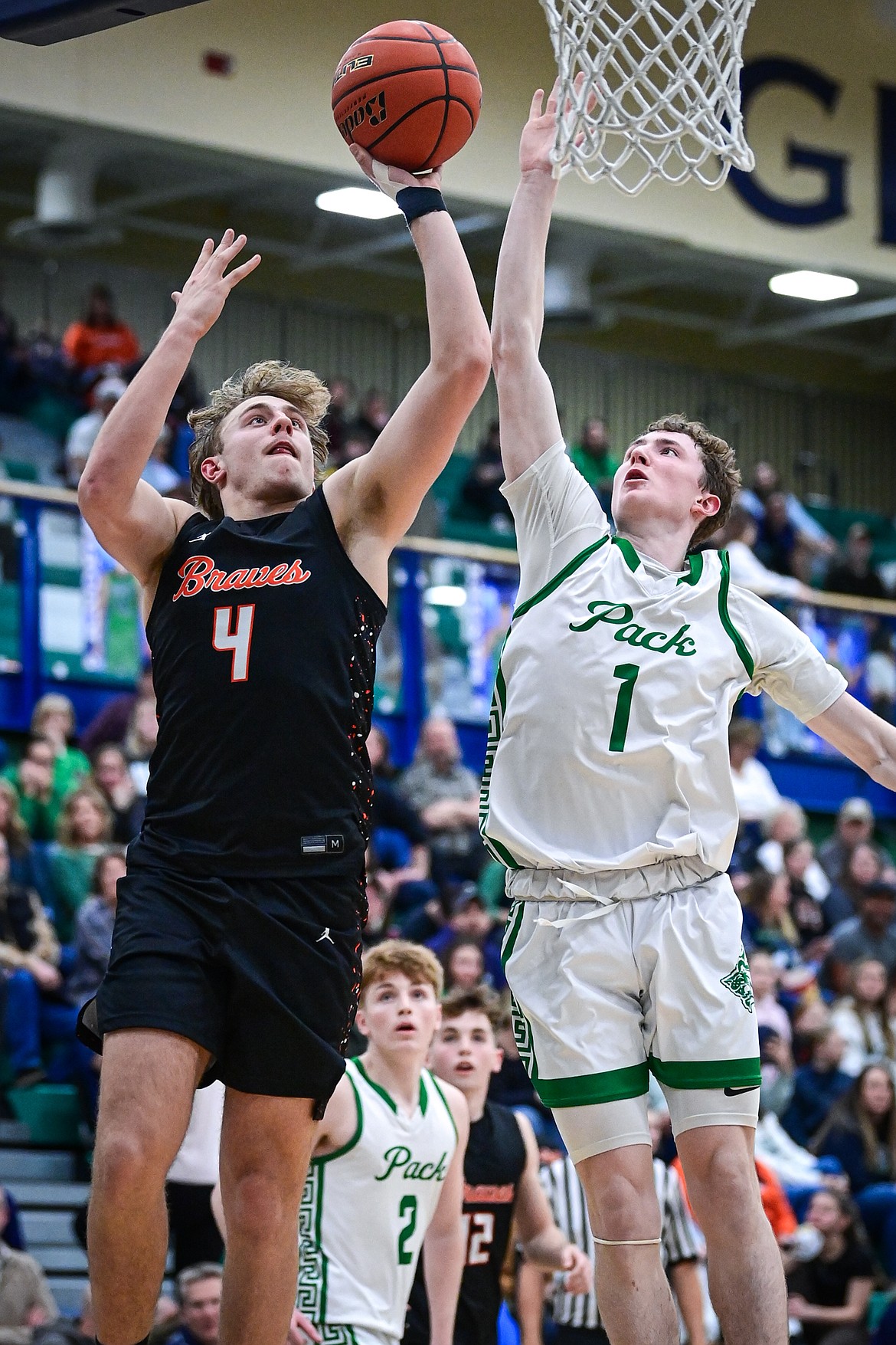 Glacier's Cooper Pelc (1) blocks a shot by Flathead's Eli Coopman (4) in the third quarter at Glacier High School on Thursday, Feb. 19. (Casey Kreider/Daily Inter Lake)