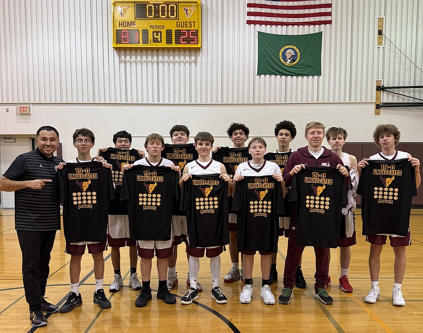 The Mavericks D-team stands together following their final game holding up T-shirts that commemorate their undefeated season. Head Coach Eric Salgado said this was a great turnaround after the team’s struggles last season.