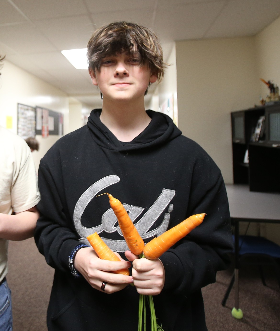 New Vision freshman Zackery Bostwick finds carrots a-peeling Thursday during a visit from Eat Smart Idaho's Health Harvest program.