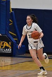 MLCA/CCS freshman Shay Kast gains possession of the ball and runs down to the other side of the court during a previous matchup against Wilson Creek this season. Kast led the Lions with 24 points in Saturday’s district final.