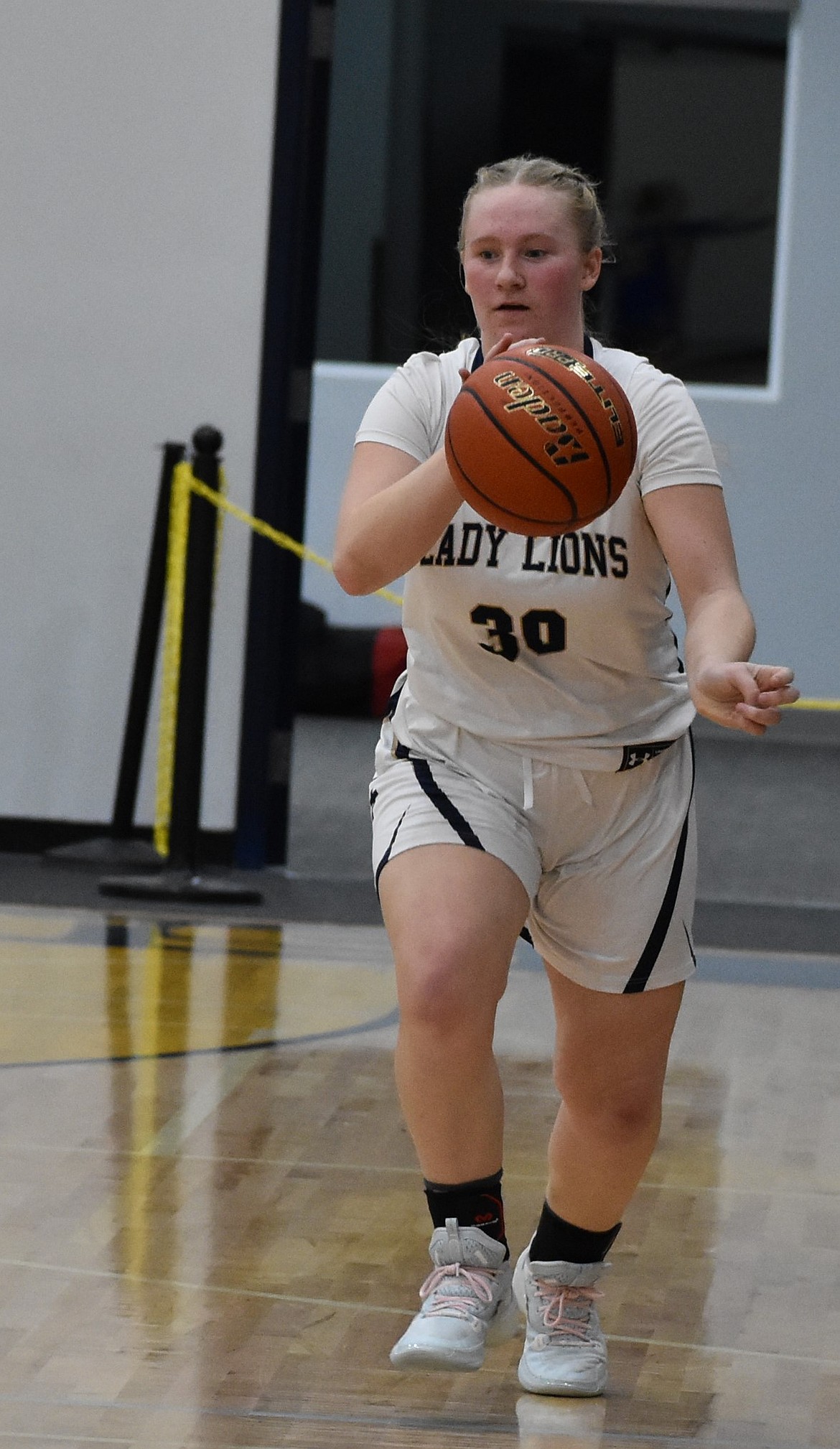 Abby Stanley, a junior from the Lions, marches along the side of the court after gaining possession of the ball earlier this season.