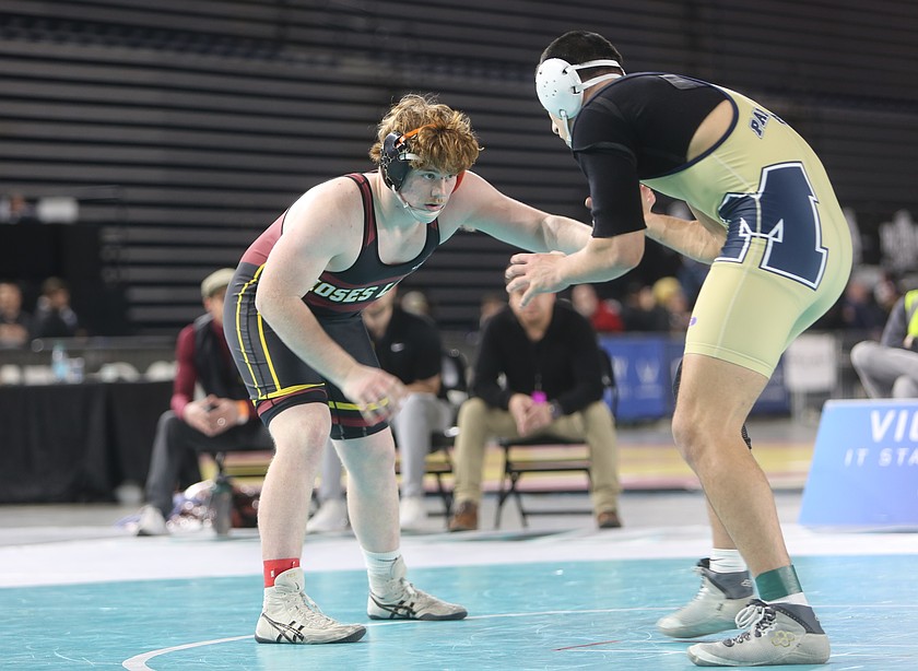 Eli Anderson, left, eyes his opponent from Mead during their finals match at the Mat Classic. Anderson fell short 4-2 in the 215 finals of the state tournament.