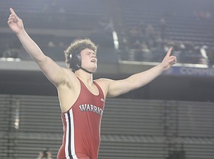 Almira/Coulee-Hartline’s Noah Butler, in red, celebrates after winning his second straight state championship at the Mat Classic Saturday. ACH had four wrestlers earn medals at the state tournament this year.