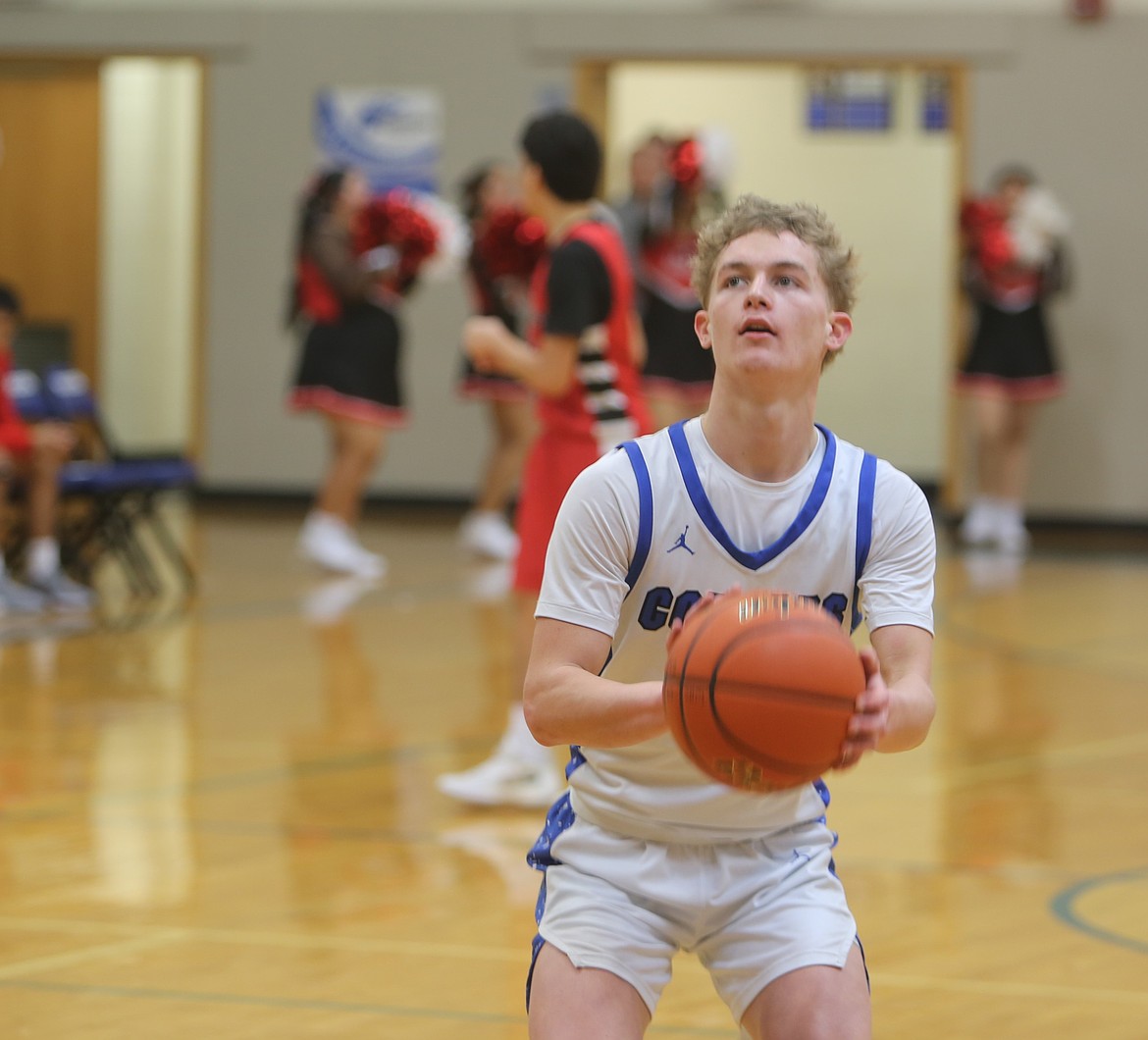 Eli Cox from the Warden Cougars prepares to shoot a free throw during a previous home game this season. The Cougars head into the first round of the state tournament this weekend where they face Adna Friday evening.