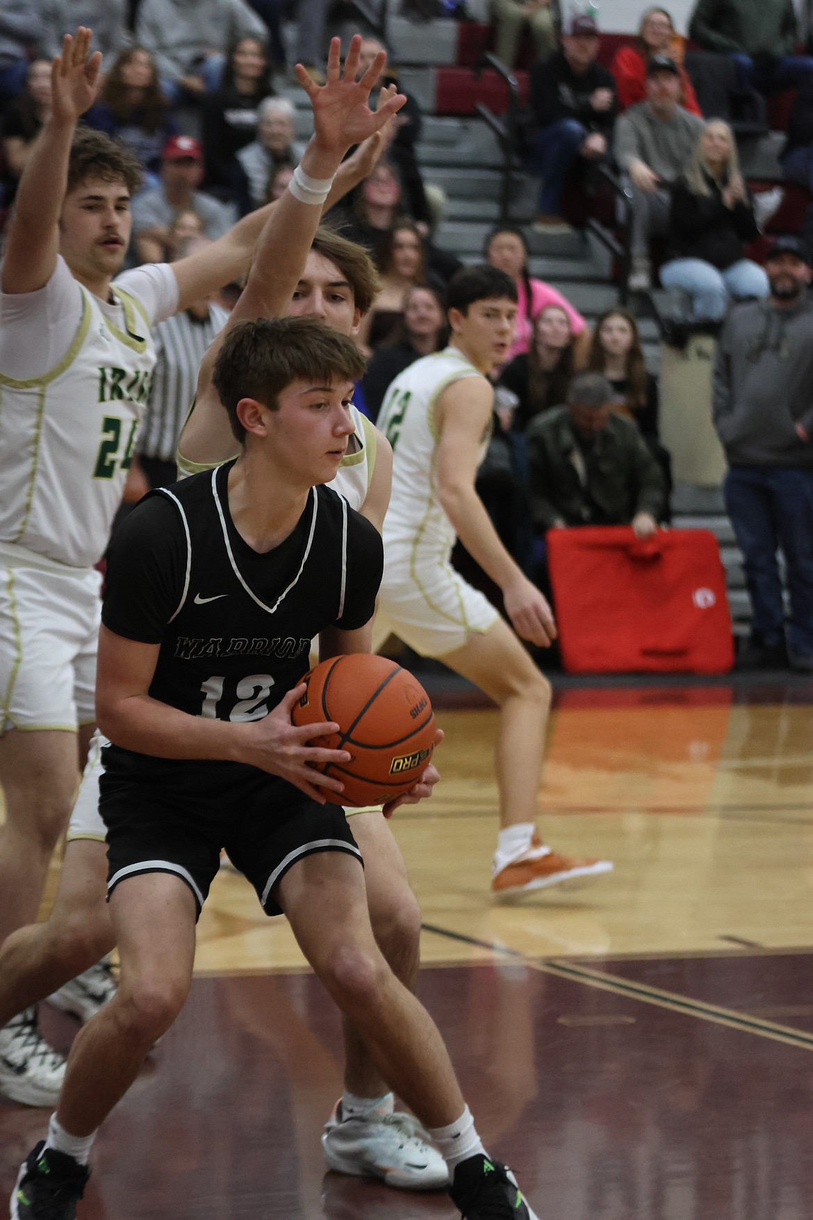 Nolan Grindy from the Warriors looks for an opening to make a play while under pressure from the DeSales’ defenders.
