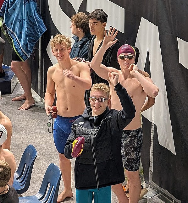 Sam Molitor, Matt Molitor and Lennox Leeder from Moses Lake stand at the edge of the pool following one of their relay events at the state tournament.