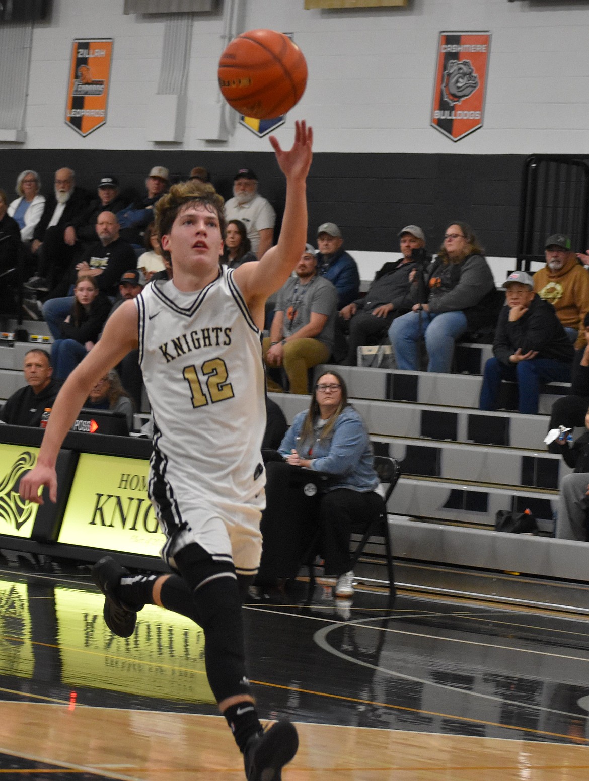 Graham Palmer, a freshman from Royal, receives the ball from a teammate as he goes in for a layup in a previous matchup this season. Palmer scored four three-pointers in Friday’s game against Zillah.