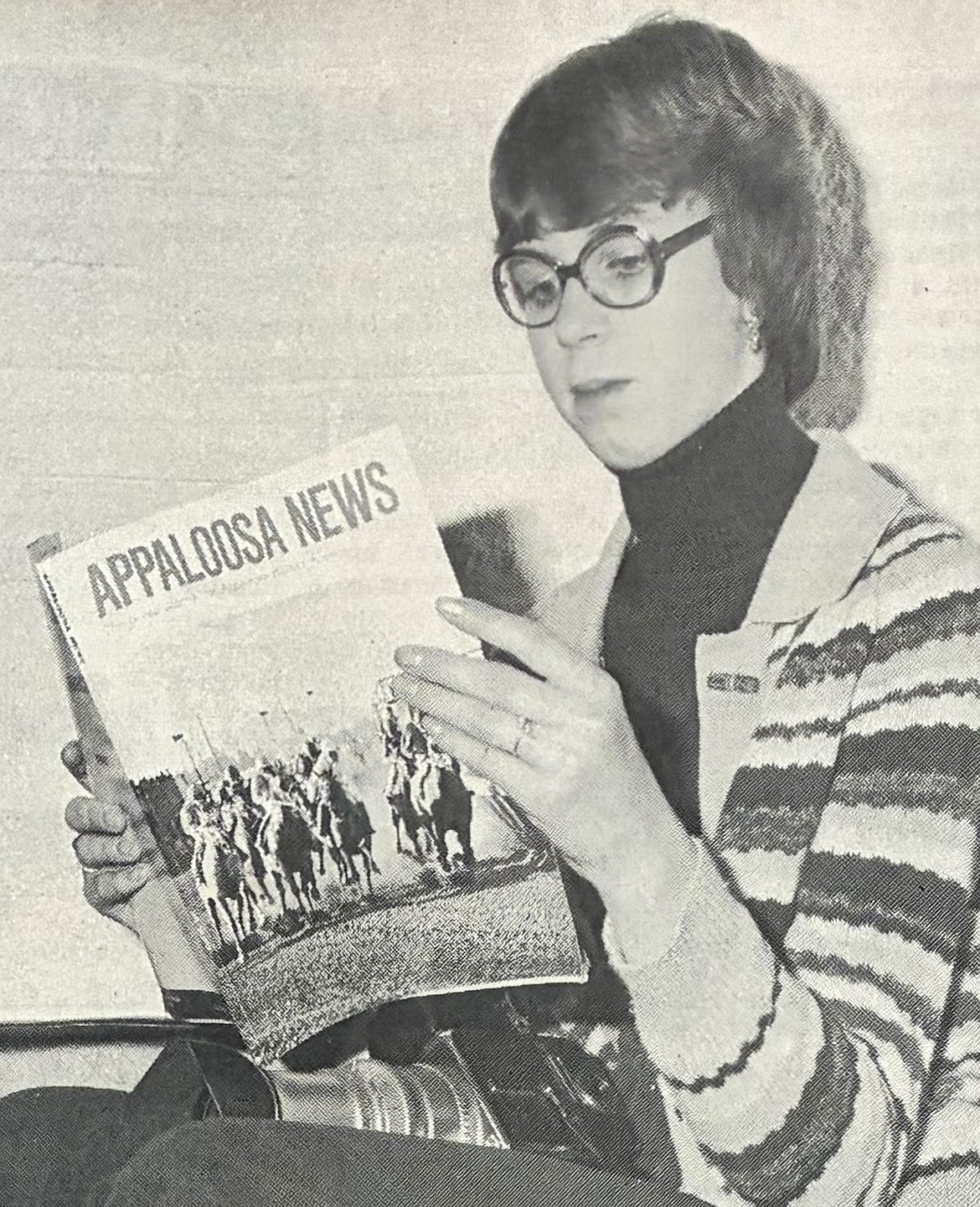 Chris Steinley Holloway, 15, reads the March 1976 edition of Appaloosa News with her racing photo on the cover.