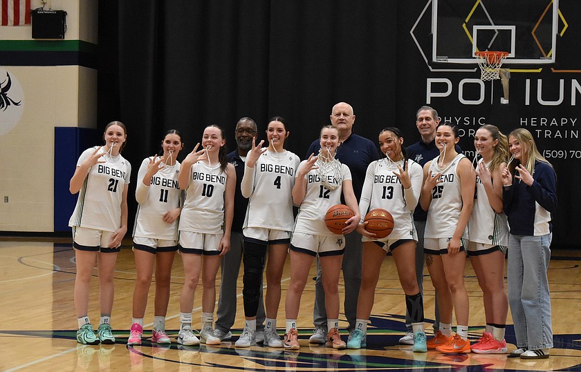The BBCC Women’s basketball players Saydee Pebley, Emily Dana, Claire Cox, Ashlynn Purcell, Oakley Homer, Kaliyah Evans, Oaklie Jackman, Mallory Henrie and Brooke Warren stand with their coaching staff in the back Ken Ballard, David Herrud and Head Coach Preston Wilks after cutting down the net to celebrate their victory.
