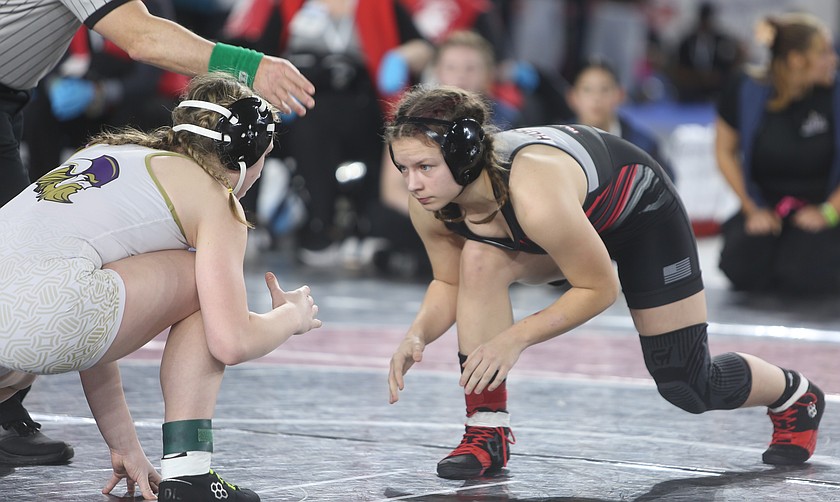 The Huskies’ Addie Russell, right, gets set for her state finals match in the Mat Classic tournament. Russell was one of five placers at state for Othello, helping them finish in second place as a team.