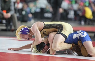 The Royal Knights’ Stratton Yorgesen, in gold, controls his opponent on the mat during his state finals match in the Mat Classic.