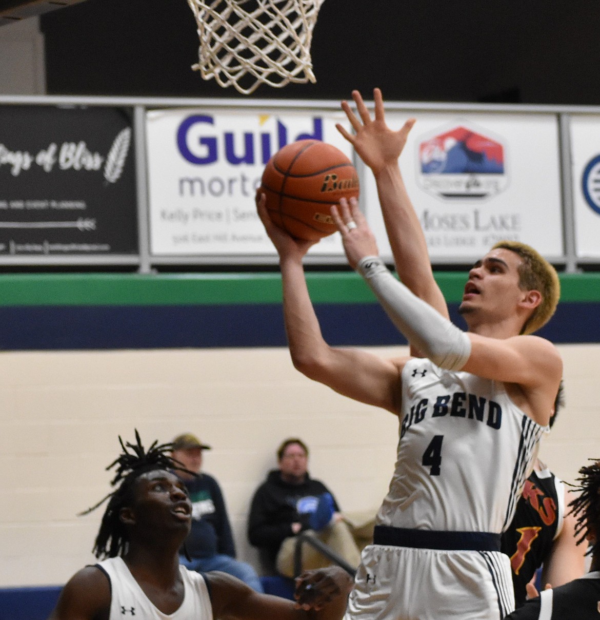 Sugar Eaton from the Vikings goes in for a layup with his teammate Mahmoud (Mo) Ibrahim standing below the net ready to provide support.