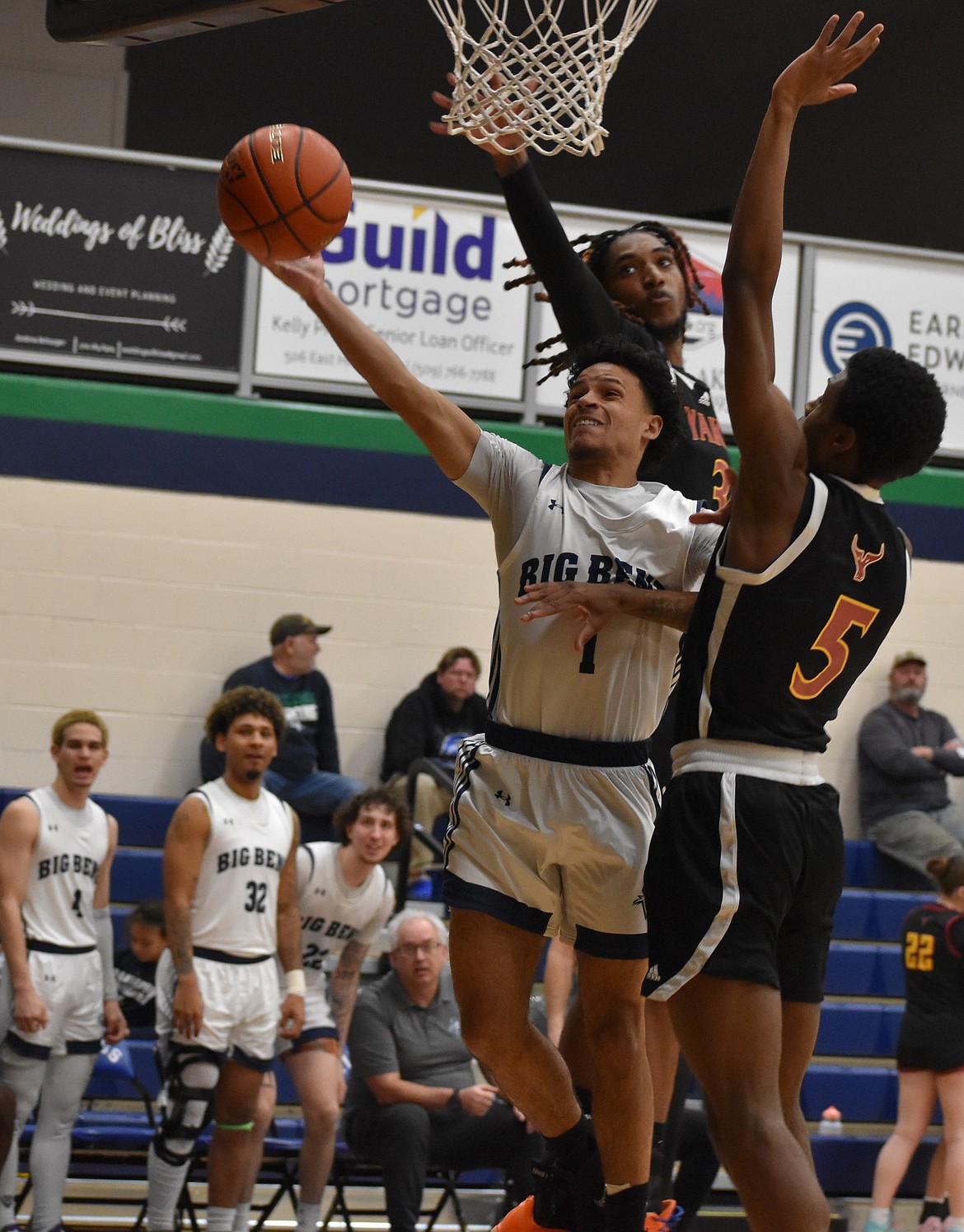 Vikings freshman Lorenzo Contreras goes in for the layup with pressure from two Yakima Valley defenders during Wednesday’s home victory.