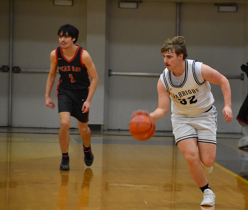 Warriors senior Caden Correia rushes down the court after gaining possession of the ball against Neah Bay in the first round of the state tourney.