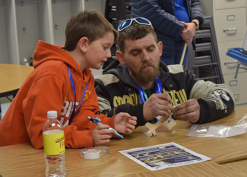 A student works with an adult to build an airplane with working lights at the Take Flight STEM Night Thursday at Longview Elementary. This was the first night of three, with two more scheduled in March and April.