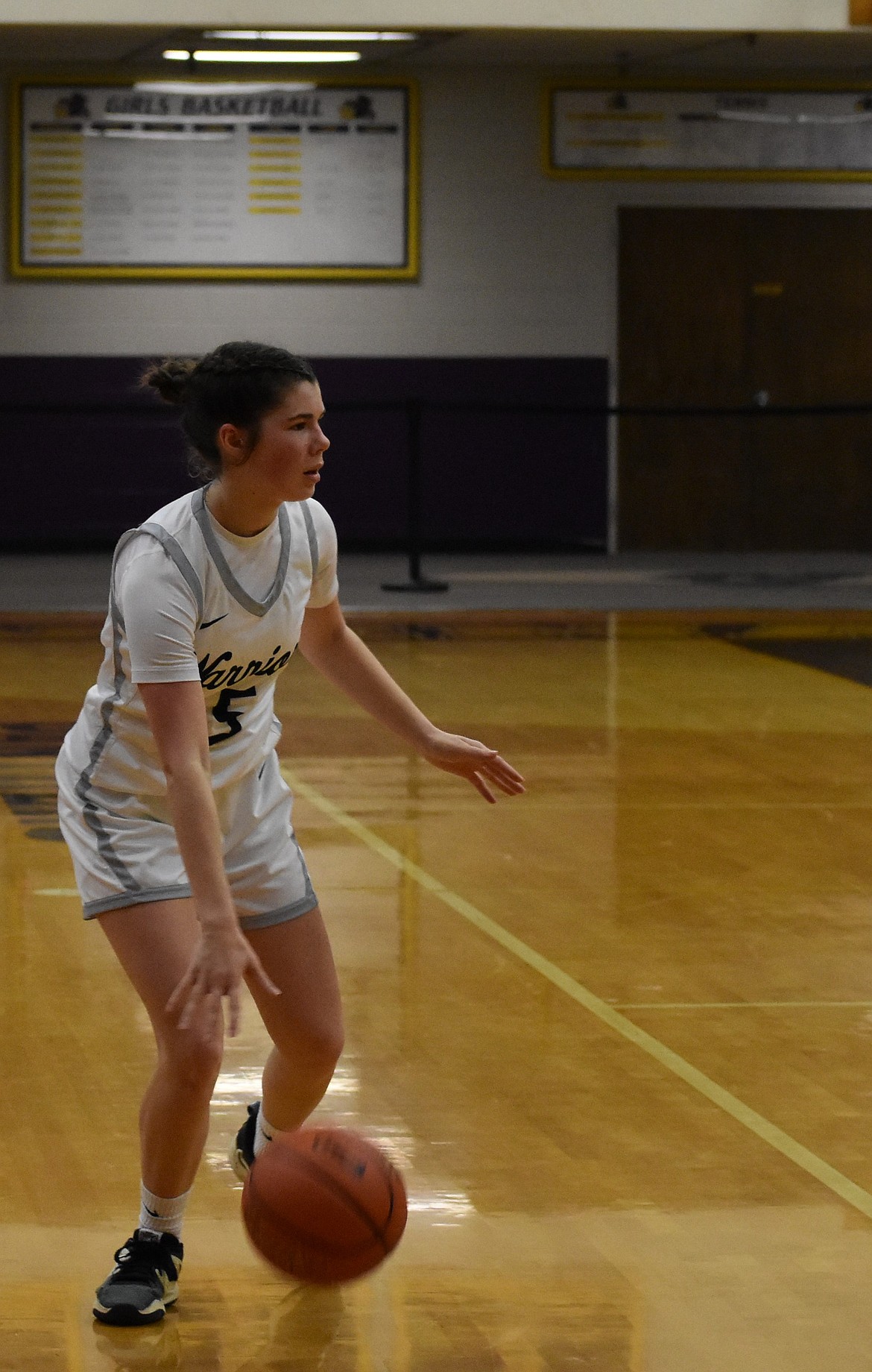 Mallory Isaak, a sophomore from the Warriors dribbles the ball along the side of the court towards the hoop against Muckleshoot Saturday afternoon.
