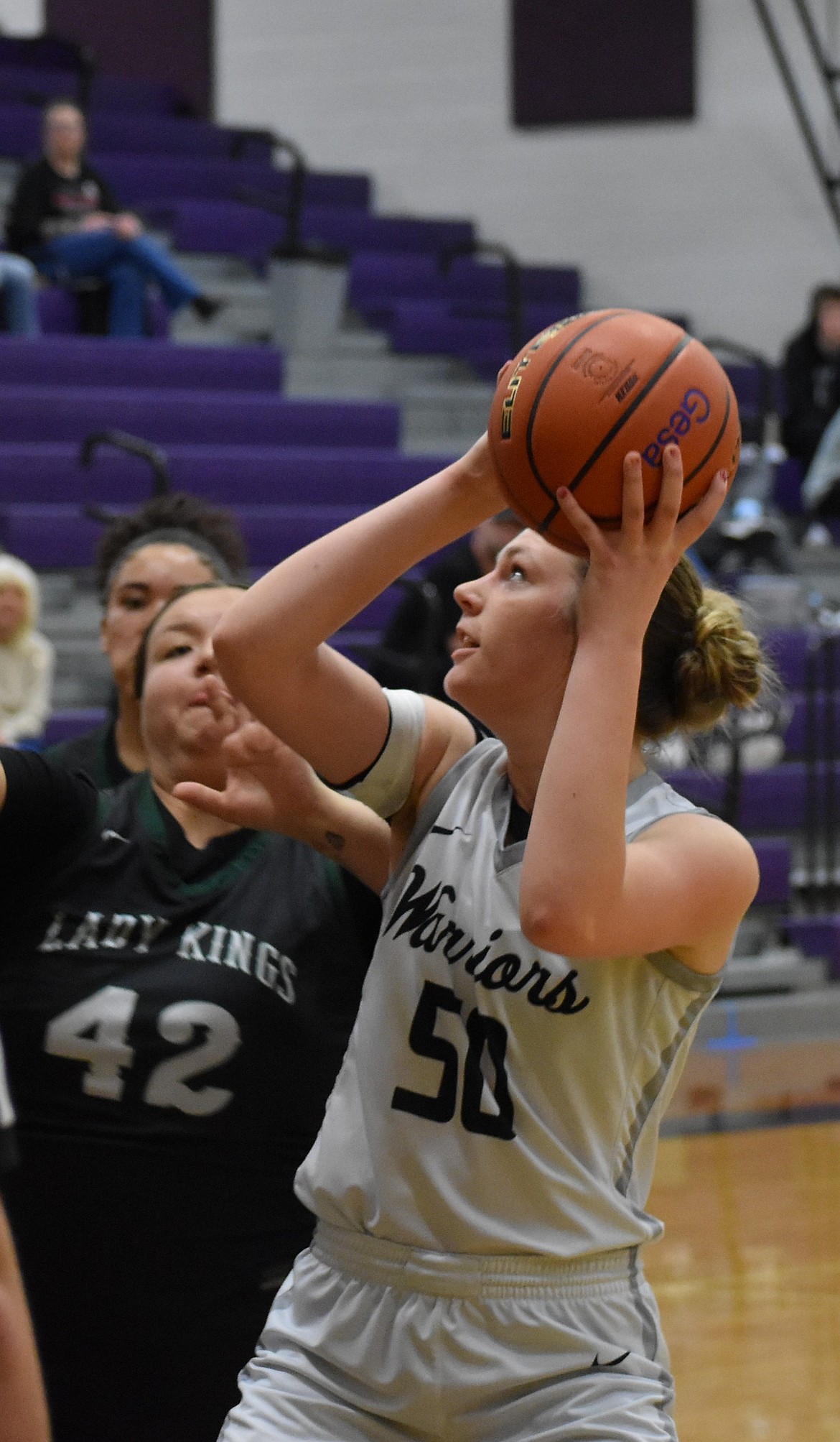 Warriors senior Emma Brummett goes for two with pressure from Muckleshoot defenders during the state tournament.