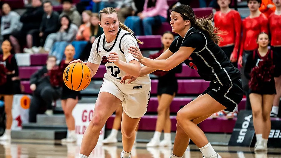 The Wildcats’ Rylee Leishman drives to the basket against a Northwest Nazarene defender Saturday. Central Washington suffered a narrow 58-56 loss in their season finale.