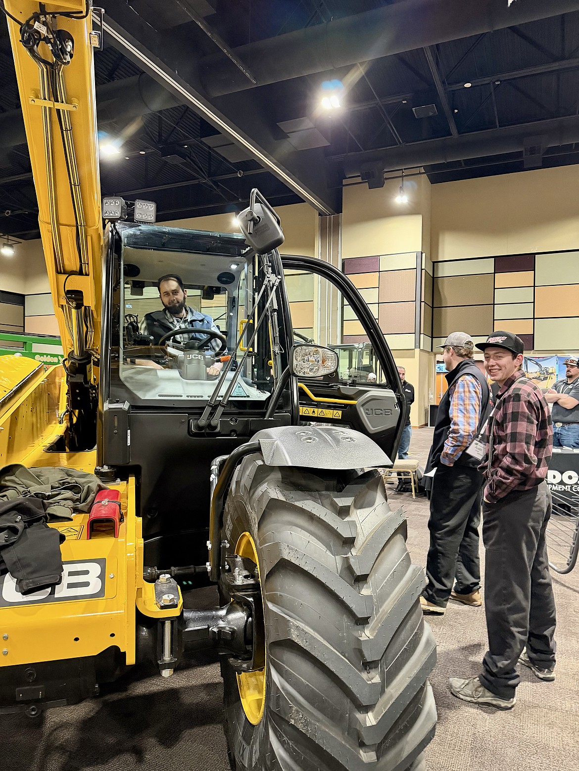 A vendor sits inside his tractor cab on the trade-show floor, ready to answer questions as producers look for ways to improve efficiency and cut costs.