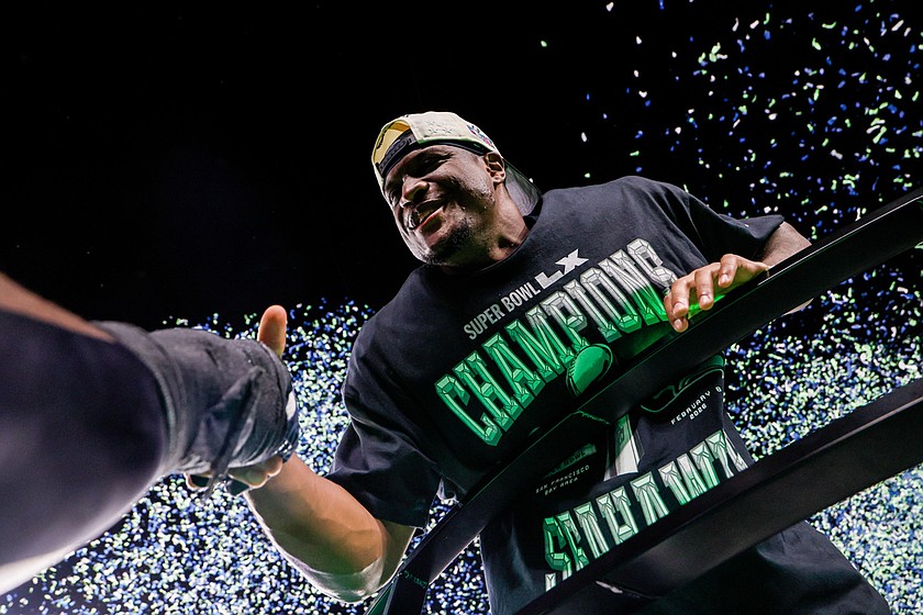 Seattle Seahawks running back Kenneth Walker III, MVP of the game, celebrates on the trophy stage as blue and green confetti rains down after the Seahawks won Super Bowl LX over the New England Patriots Sunday, Feb. 8, 2026, in Santa Clara, California.