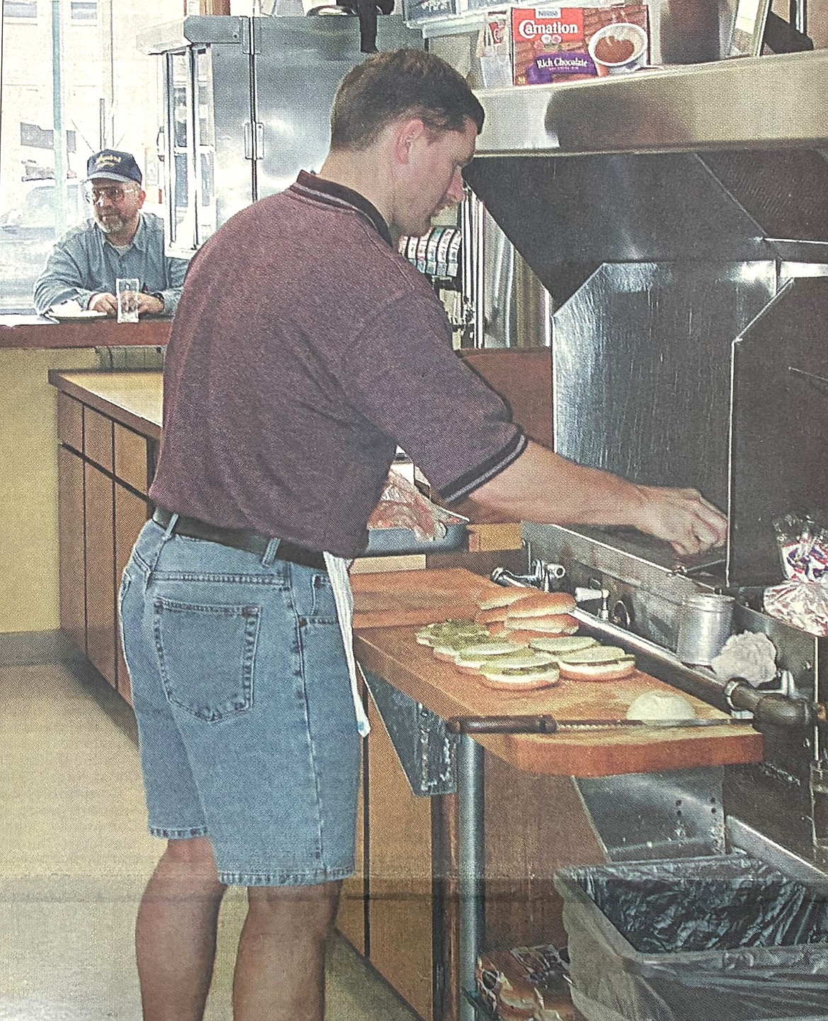As he flips burgers in 2001, Steve Hudson is unconcerned about rising meat prices.