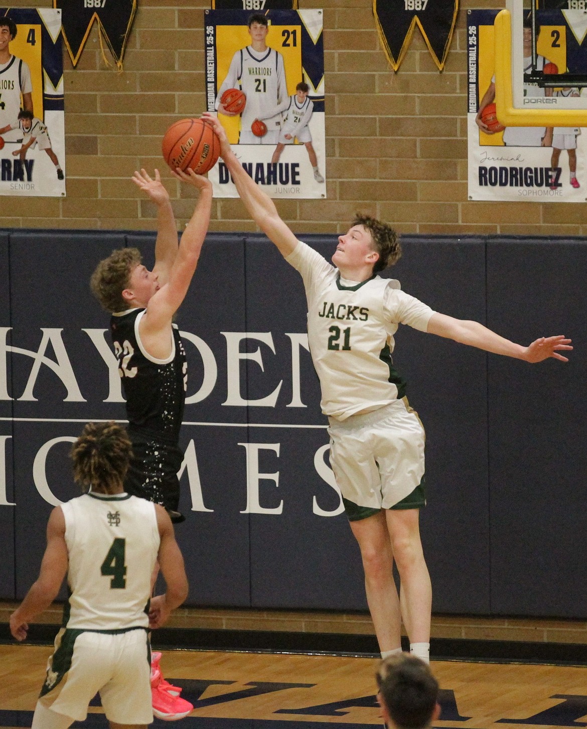 MARK NELKE/Press
St. Maries junior Landon Riberich (21) blocks a shot by Parma senior Colton Davison (22) in the first half of a state 3A boys first-round game Thursday at Meridian High.
