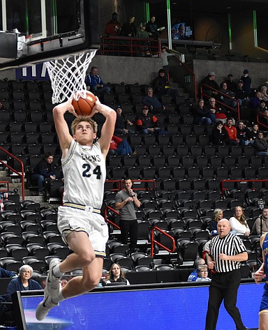Lions senior Johnny Ferguson goes in for the dunk during the third quarter against Columbia Adventist in the 1B state semifinals.
