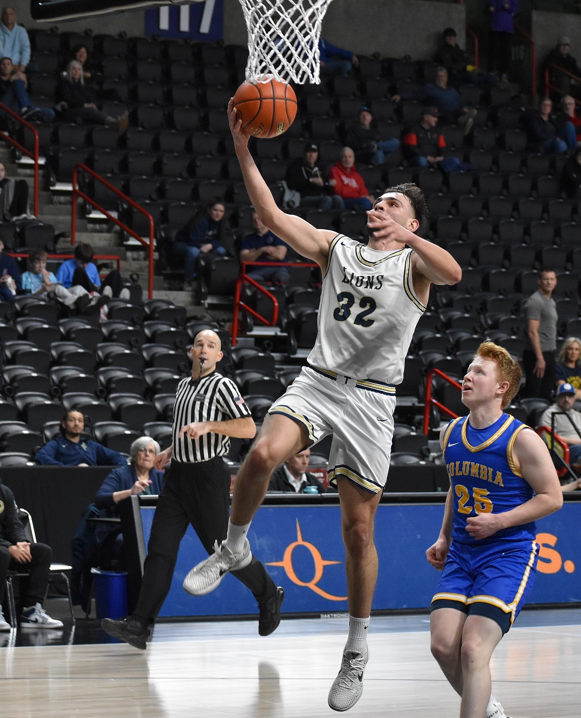 Lions senior Dennis Gulenko leaps up to make a layup during the 1B state semifinals against Columbia Adventist.
