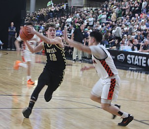 Graham Palmer (12) drives the ball into the paint against a Zillah defender. The Royal Knights suffered a loss to the Zillah Leopards in the 1A state basketball semifinals Friday.