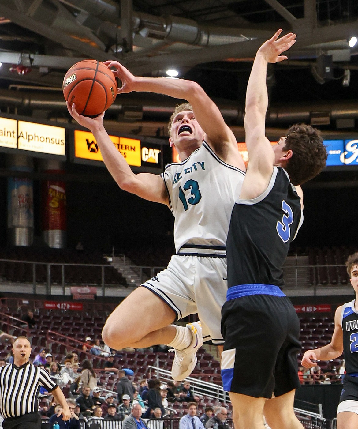 JASON DUCHOW PHOTOGRAPHY
Lake City senior guard Jackson Bowman drives to the basket as Timberline senior JD Focarile defends during the second half of Thursday's state 6A boys basketball opening round game at the Ford Idaho Center in Nampa. Lake City defeated Timberline 48-37 to advance to the semifinals tonight at 6 PST against Centennial High of Boise.